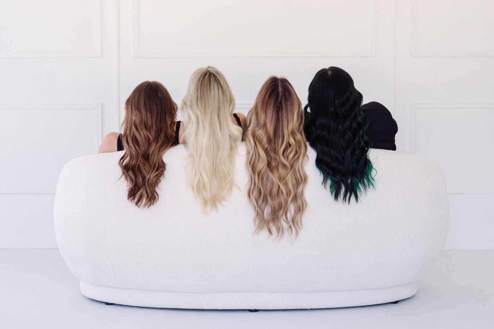 Four La Mode clients showing copper, platinum blonde, bronde balayage and black-to-emerald hair colour