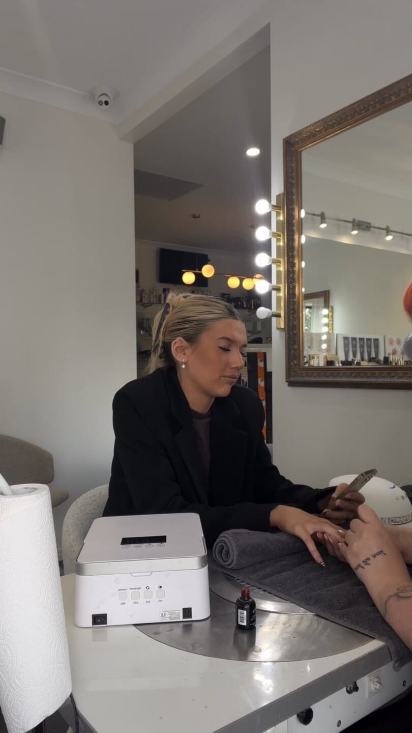Nail technician shaping a fresh set of gel nails at the nail desk at La Mode Gympie