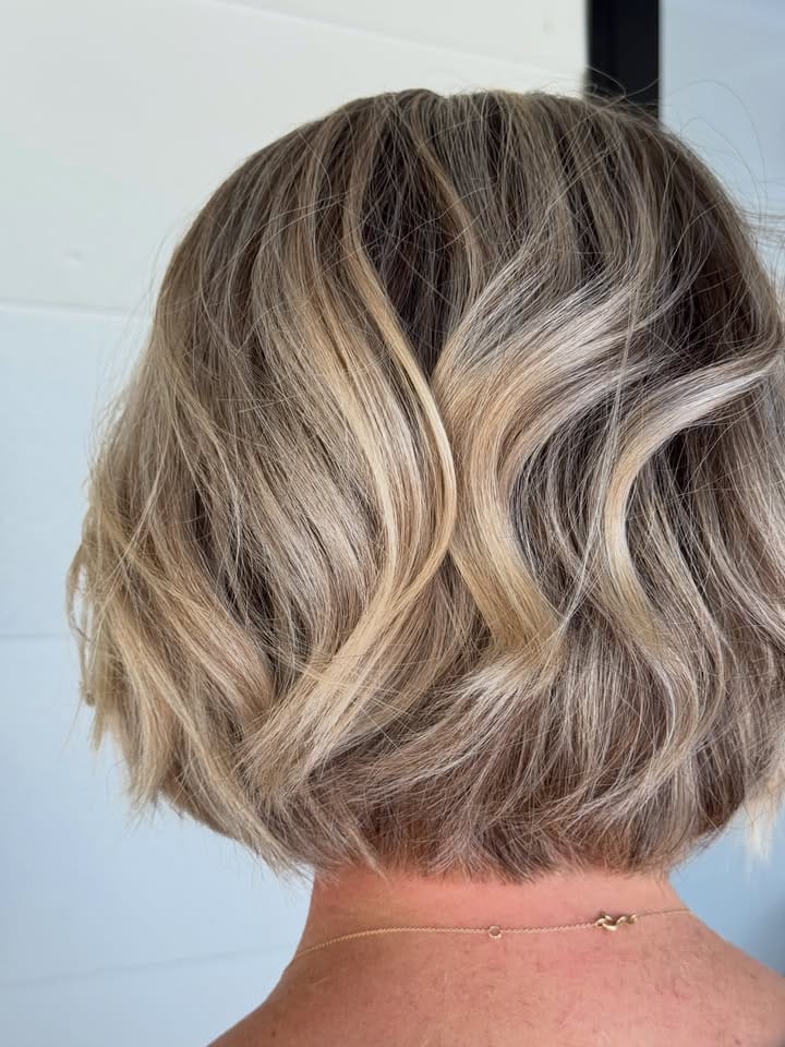 Bright blonde colour with soft waves, finished in the salon at La Mode Gympie
